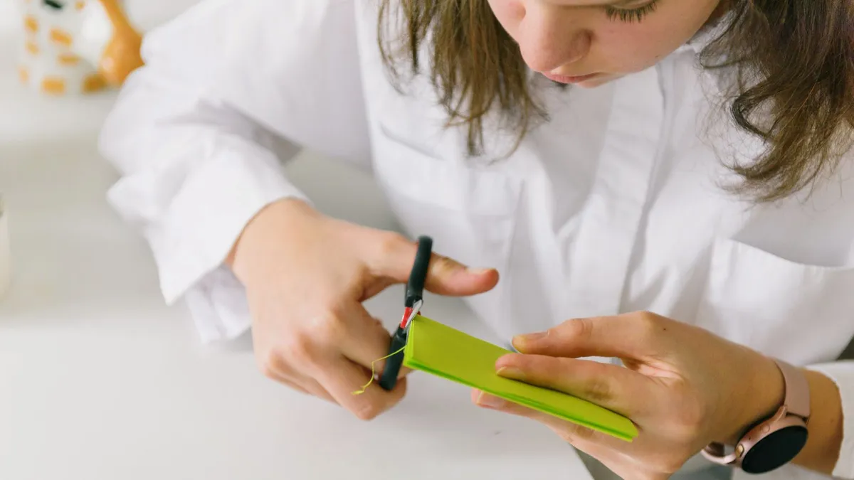 Person cutting up a credit card with scissors after their balances were included in a consumer proposal