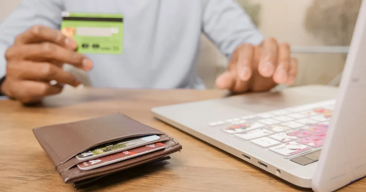 Several credit cards spread on a table beside statements, the starting point of credit card debt forgiveness in Canada