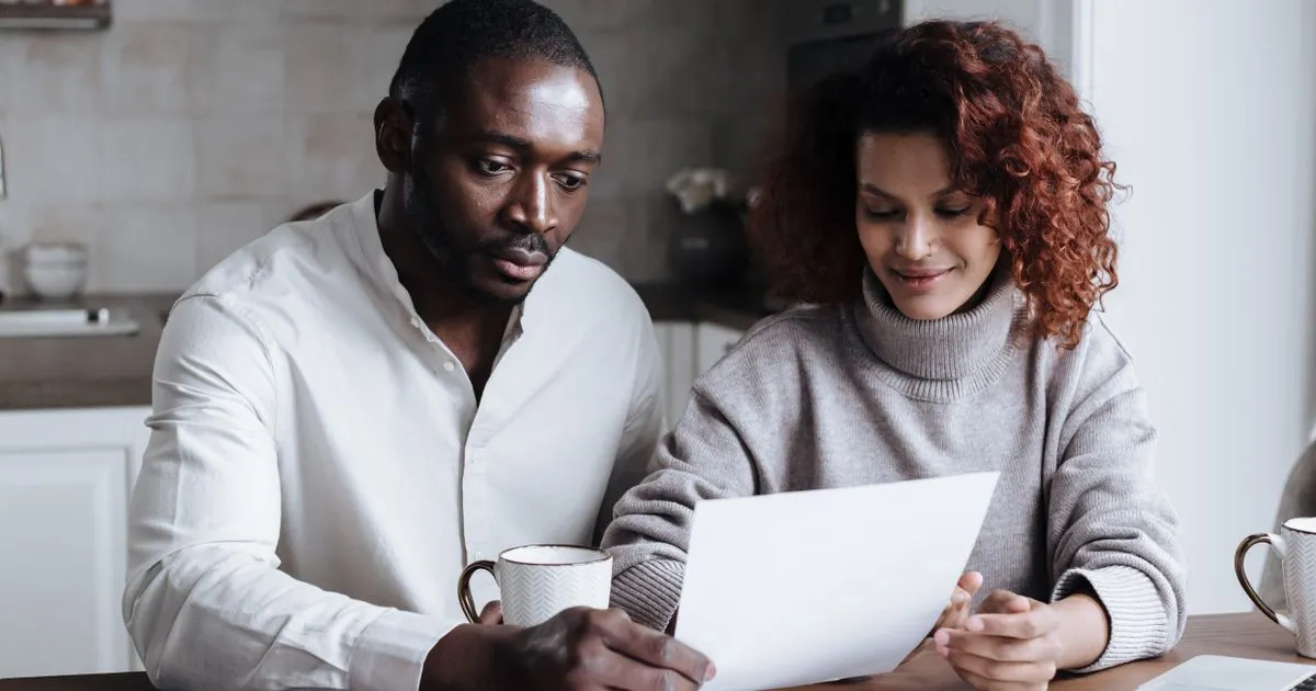 Couple at a kitchen table reviewing debt relief options in Canada together