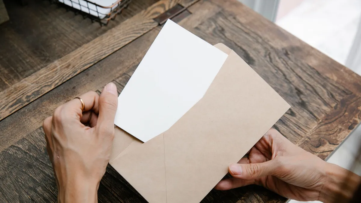 Person reading a letter about debt relief grants and government programs at home